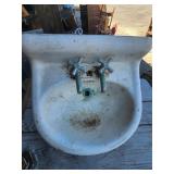 Antique white porcelain cast iron sink.  There