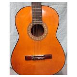 Acoustic guitar. BRIDGE is pulled up on bottom.