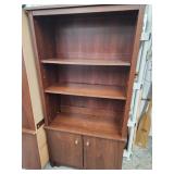 Pressboard bookcase with 2 door base.  61" H x