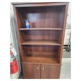 Pressboard bookcase with 2 door base.  61" H x