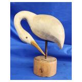 Eastern shore carved egret shore bird preening.
