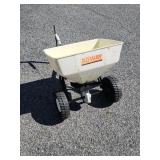 Older tow behind broad cast spreader.   PICK UP