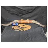 Decorative bull horns and leather tie belt.