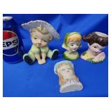 3 head vases and 1 head vase wall pocket.