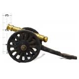 Miniature cast iron cannon on wheels
