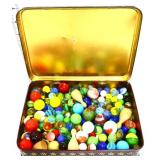 Lot of marbles in biscuit tin