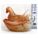Miniature amber marble hen on nest