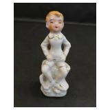 Vintage Porcelain Figurine of Boy Sitting on Stump