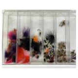 SEVERAL FLY FISHING LURES IN PLASTIC ORGANIZER