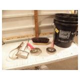 BUCKET OF HORSE GROOMING TOOLS