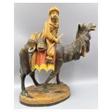 Wooden Figurine Featuring Man Riding Camel