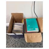 Box of copy paper and spiral notebooks
