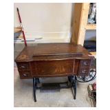 Antique sewing machine in cabinet