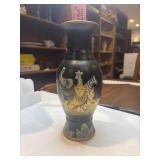 Vintage matte black ceramic vase featuring hand