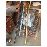 Five vintage walking sticks and two umbrellas