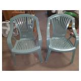 2 green lawn chairs