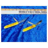 Two vintage USA Coca-Cola knives