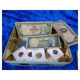 Metal tin with coins and paper money