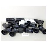 White PVC and Black ABS Plastic 4" Pipe Fittings