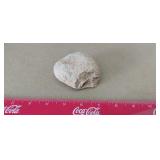 Small, weathered, light-gray or tan rock