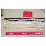 Three long beaded necklaces.