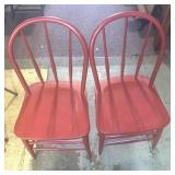 To primitive wooden chairs