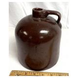 7" Tall stoneware jug chip on bottom
