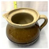Stoneware pitcher  has cracks