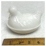 Miniature white hen on nest