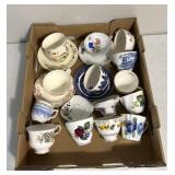 Variety of tea, cups, and plates some matching
