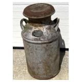 Vintage metal milk can with tar/signage