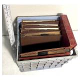 Unsorted vintage records with plastic crate