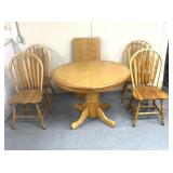 Oak table with four matching chairs, one leaf