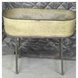oval galvanized metal wash tub set on a metal