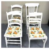 4 white chairs with orange themed seating material