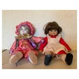 Two Porcelain Dolls in Costume Attire