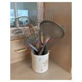 Metal whisks , mashers and strainers in utensils
