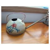 Tin plant waterer    (behind kitchen bar)