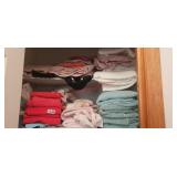 Towels and linens on these top two shelves
