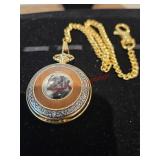 Gold colored pocket watch