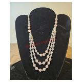 .Three strands of pink and green beads d