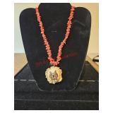 Coral colored stones and bone carved necklace