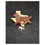 Handcarved dog on the state of texas with a