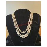 Three strands of white and clear beads.