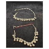 Two silver colored jingle bell bracelets