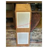 Two B&W brand speakers housed in custom wooden