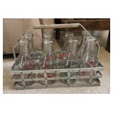 vintage metal milk bottle carrier with six glass