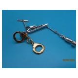 (2) vtg Tie Clips Handcuffs & Bomb