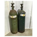 2 compressed, oxygen tanks 24" tall empty