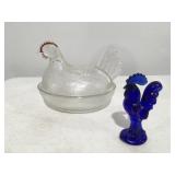 Hen on a nest and cobalt blue rooster